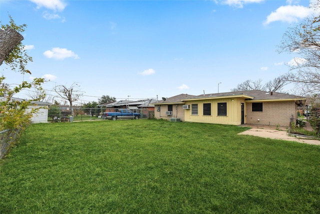 rear view of property featuring a lawn