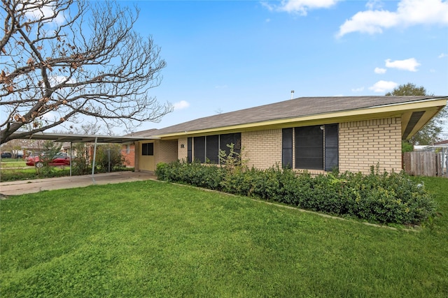 view of front of property with a carport and a front lawn