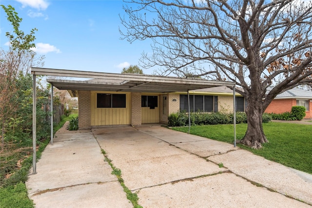 single story home with a front yard and a carport