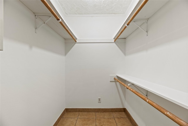 spacious closet featuring tile patterned floors