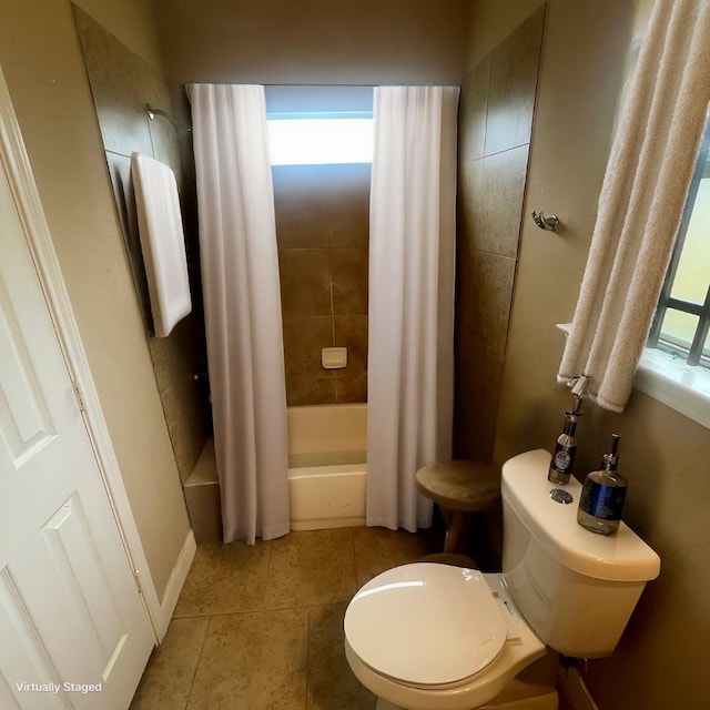 bathroom with tile patterned flooring, toilet, a healthy amount of sunlight, and shower / bath combo with shower curtain