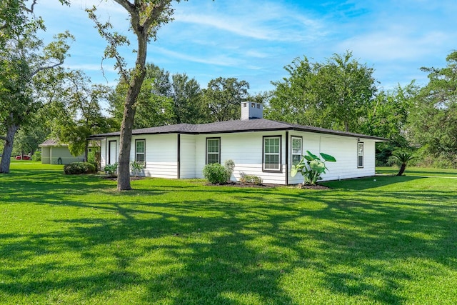 back of house with a yard