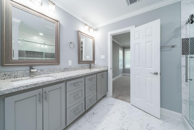 bathroom with vanity, a shower with shower door, and ornamental molding