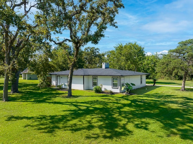 rear view of property featuring a yard