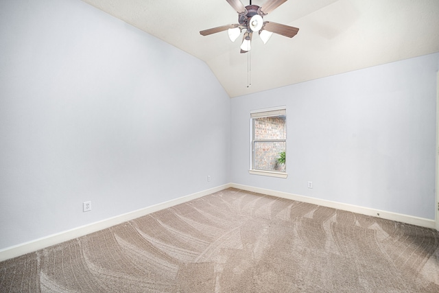 carpeted empty room with ceiling fan and lofted ceiling