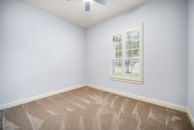 empty room featuring ceiling fan and carpet floors