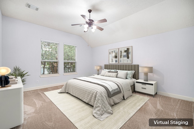 bedroom with light colored carpet, vaulted ceiling, and ceiling fan