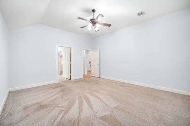 unfurnished bedroom with ceiling fan, light colored carpet, and vaulted ceiling