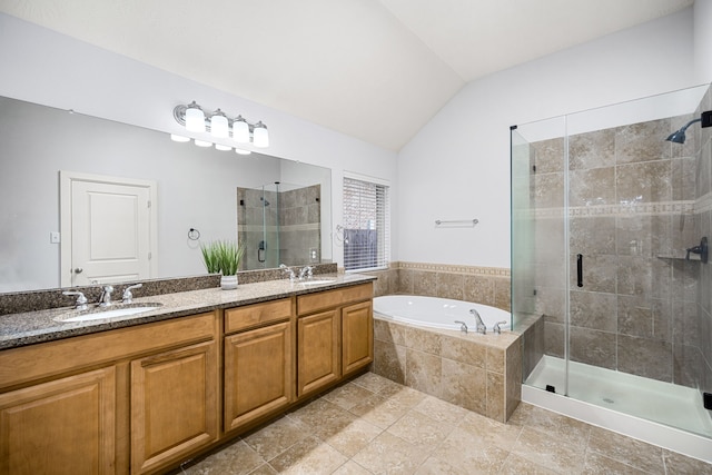 bathroom with vanity, lofted ceiling, and independent shower and bath