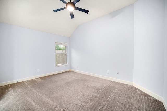 carpeted spare room featuring ceiling fan and lofted ceiling