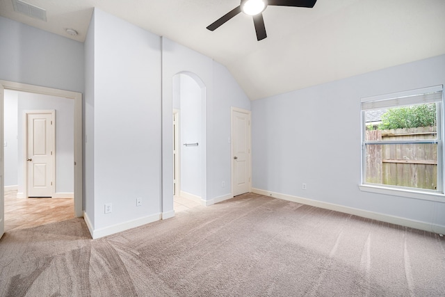 unfurnished bedroom featuring light carpet, ceiling fan, and lofted ceiling