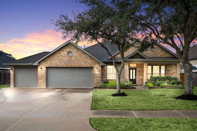 view of front facade with a lawn and a garage