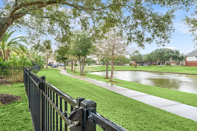 view of property's community featuring a yard and a water view