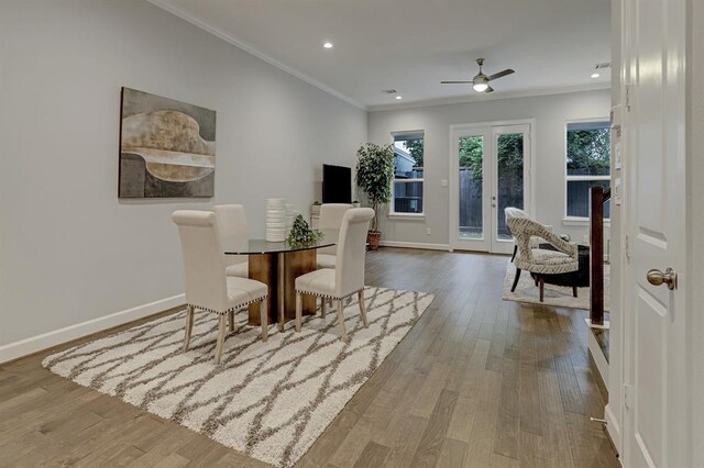 dining room featuring crown molding, hardwood / wood-style floors, ceiling fan, and french doors