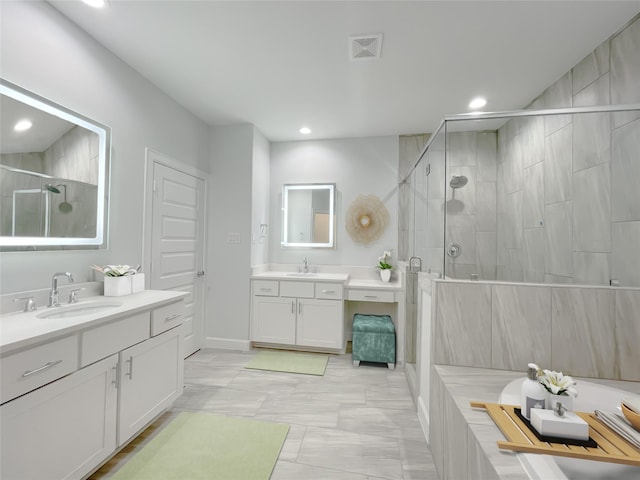 bathroom featuring a shower with door and vanity