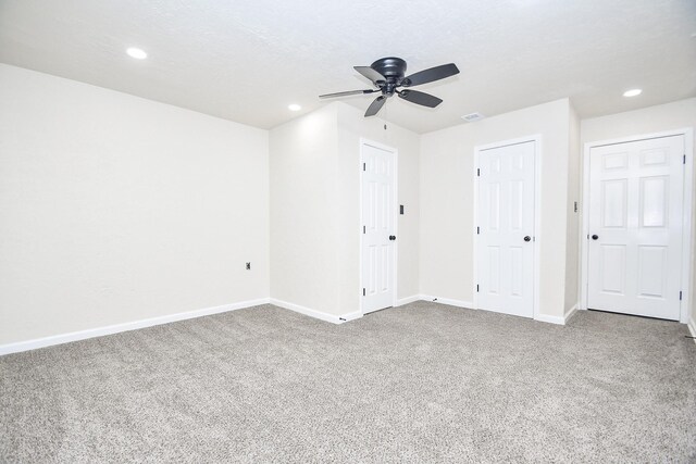 unfurnished room featuring carpet, a textured ceiling, and ceiling fan