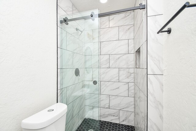 bathroom with an enclosed shower and toilet