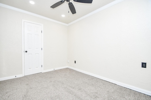 carpeted empty room featuring ceiling fan and crown molding