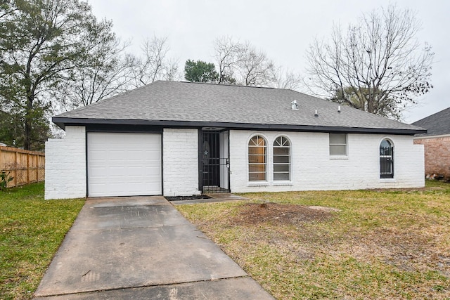 ranch-style house featuring a garage and a front lawn