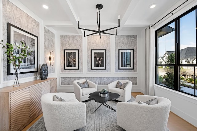 living room with beam ceiling, hardwood / wood-style floors, coffered ceiling, and a notable chandelier