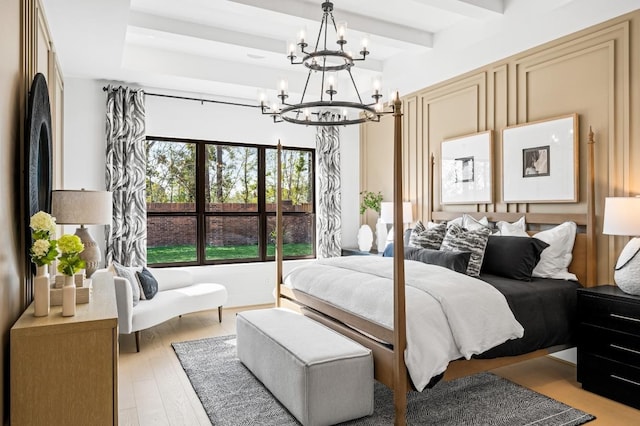 bedroom with a chandelier, light hardwood / wood-style flooring, and beamed ceiling