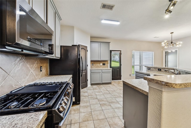 kitchen featuring a chandelier, appliances with stainless steel finishes, gray cabinets, and sink