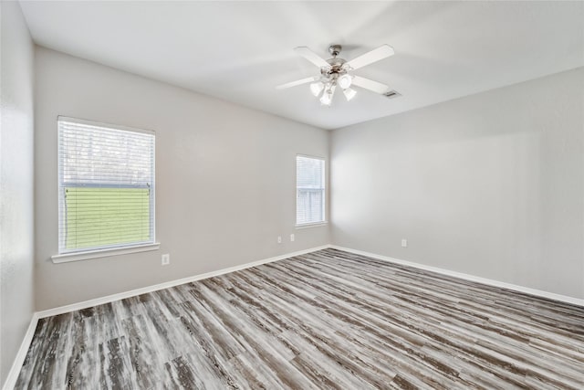 unfurnished room with hardwood / wood-style floors and ceiling fan