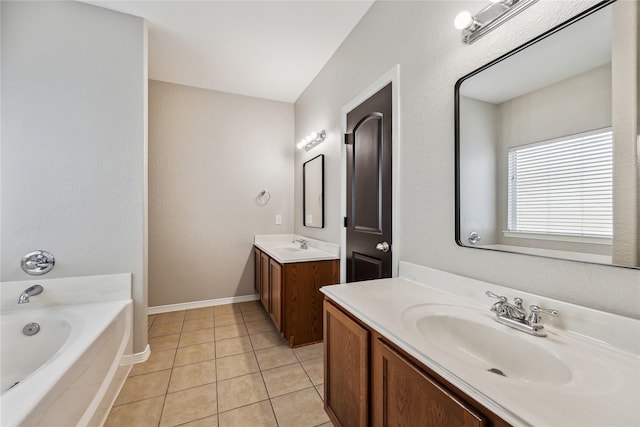 bathroom featuring tile patterned flooring, vanity, and tiled bath