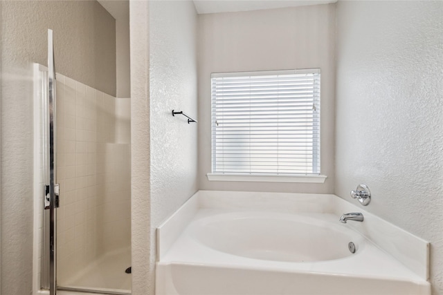 bathroom with plus walk in shower and a wealth of natural light