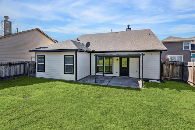 back of house with a lawn and a patio