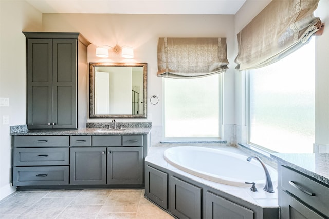 bathroom featuring vanity and a tub to relax in