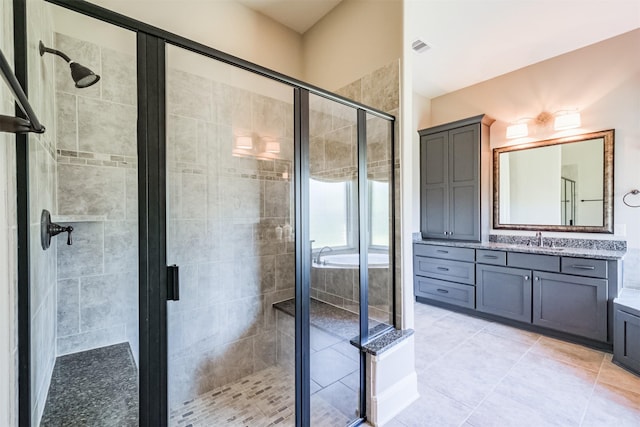 bathroom featuring tile patterned floors, vanity, and an enclosed shower