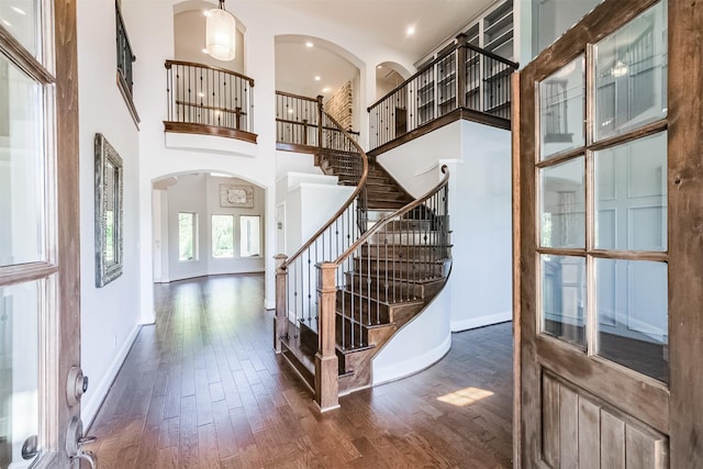 entryway with a high ceiling and dark hardwood / wood-style floors