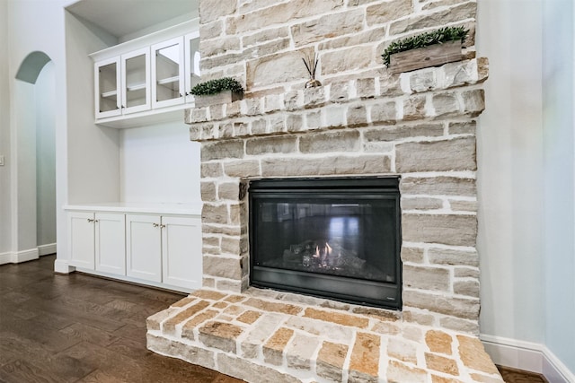 interior details featuring a stone fireplace and hardwood / wood-style floors