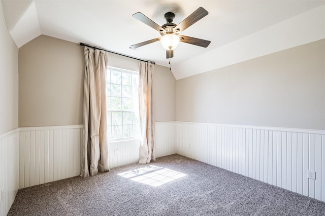 spare room featuring ceiling fan, carpet, and vaulted ceiling