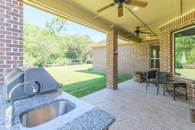 view of patio / terrace featuring ceiling fan and sink