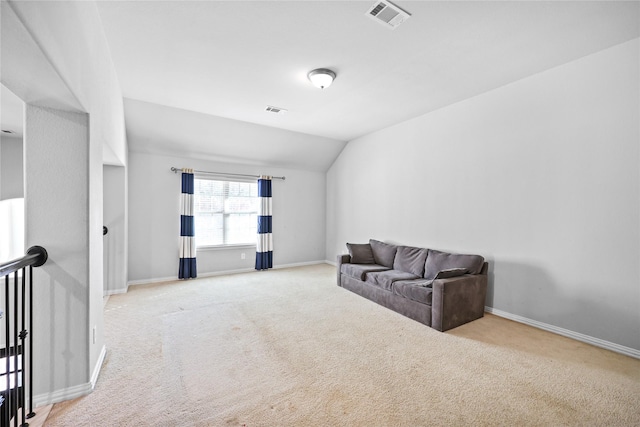 carpeted living room with vaulted ceiling