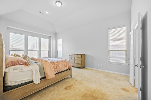 bedroom featuring lofted ceiling and light colored carpet