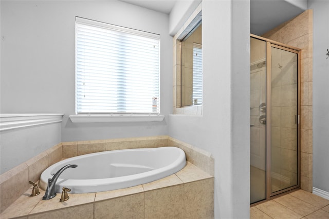 bathroom with separate shower and tub and tile patterned floors