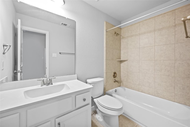 full bathroom with tiled shower / bath combo, vanity, and toilet