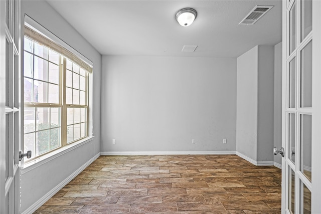 spare room with wood-type flooring