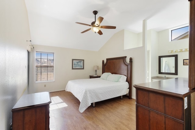 bedroom with ceiling fan, lofted ceiling, and light wood-type flooring