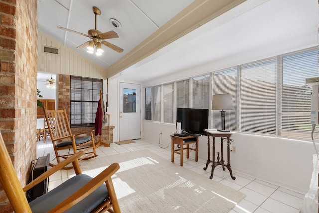 sunroom with ceiling fan and vaulted ceiling