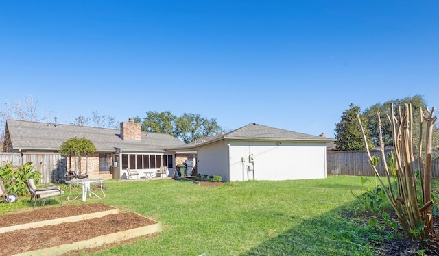 rear view of property with a lawn