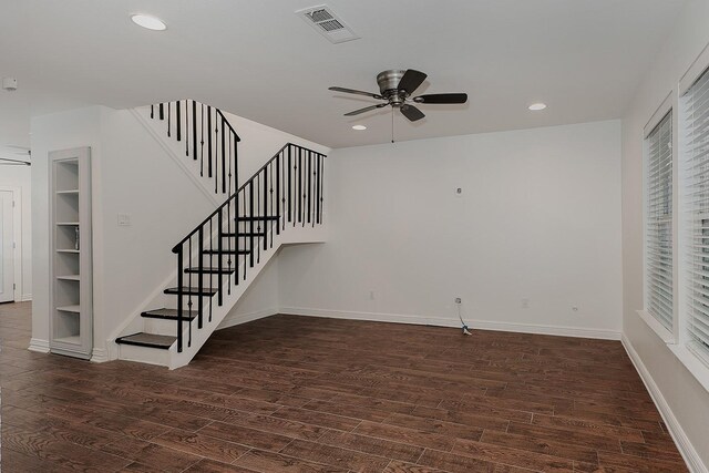 unfurnished living room with built in features, ceiling fan, and dark hardwood / wood-style floors