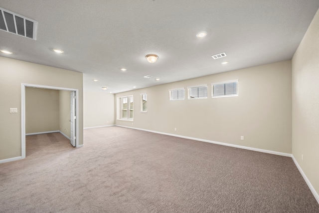 basement featuring carpet floors and a textured ceiling