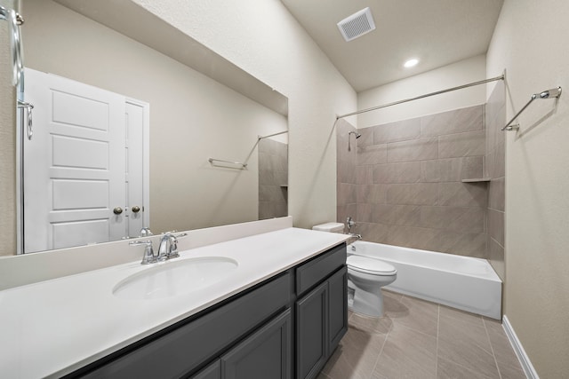 full bathroom with tile patterned flooring, vanity, toilet, and tiled shower / bath