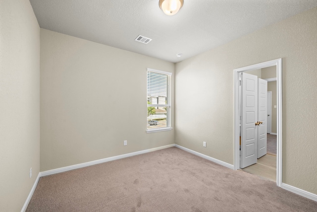 unfurnished bedroom featuring light carpet