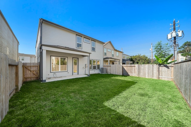 rear view of property with central AC, a yard, and a patio