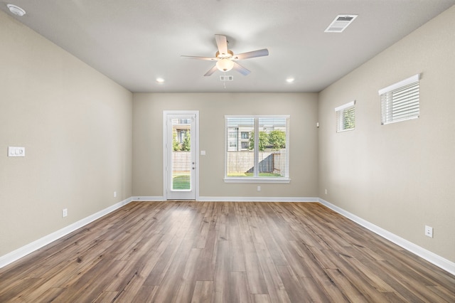 empty room with ceiling fan and wood-type flooring